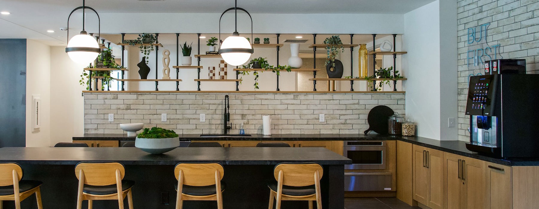 a resident kitchen with plants and a coffee machine